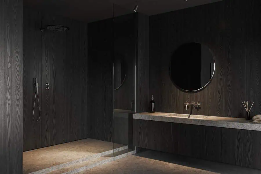 Minimalist black bathroom with a sleek walk-in shower and modern chrome fixtures.