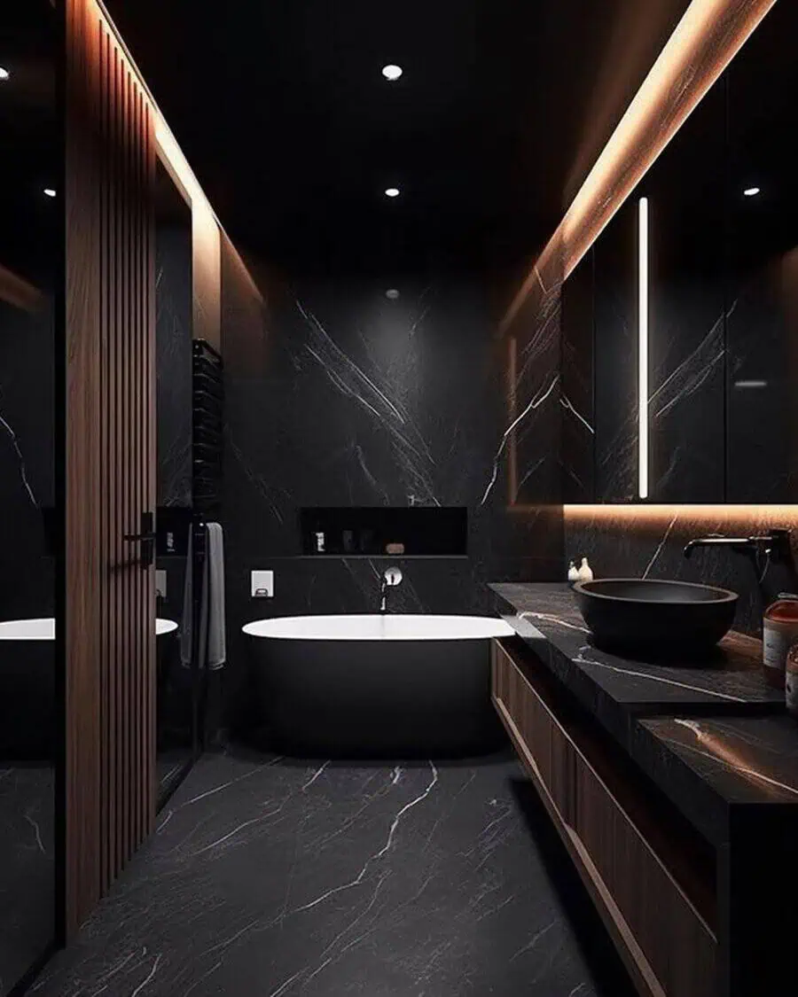 Modern black bathroom with a freestanding tub, marble walls, and warm LED lighting.