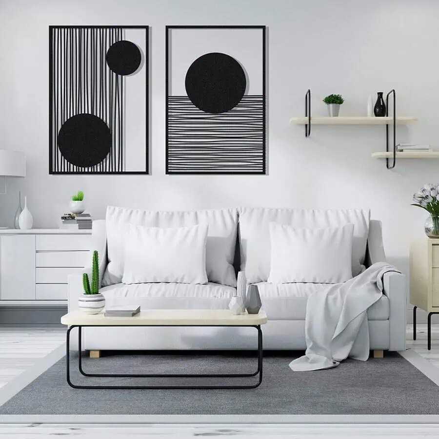 Modern grey and white living room with minimalist decor, abstract wall art, and a cozy sofa.