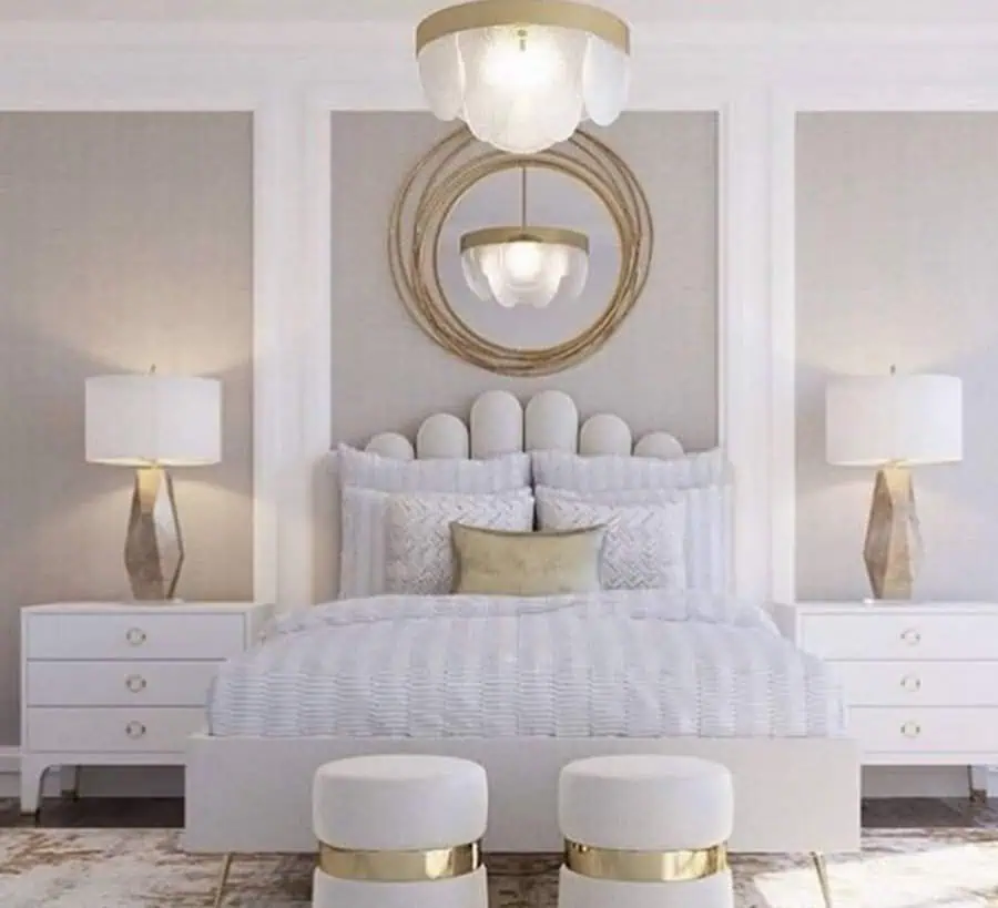 Modern grey and white bedroom with gold accents, stylish lighting, and a unique tufted headboard.