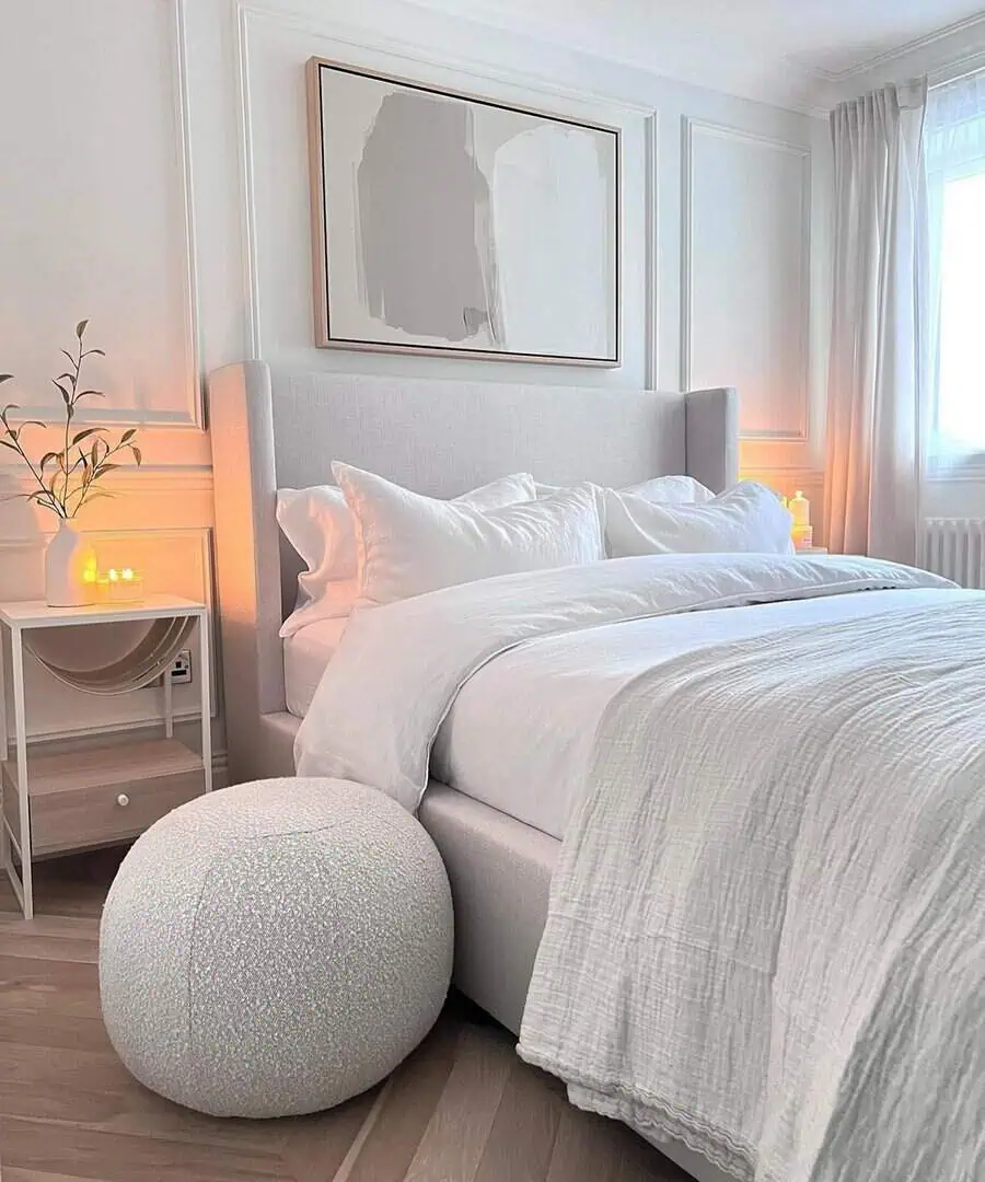 Grey and white bedroom with a sleek storage solution, soft bedding, and elegant decor.