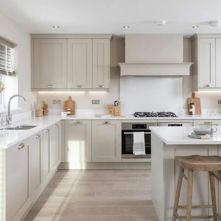 Simple modular kitchen design with neutral cabinets, white countertops, and a functional L-shaped layout.