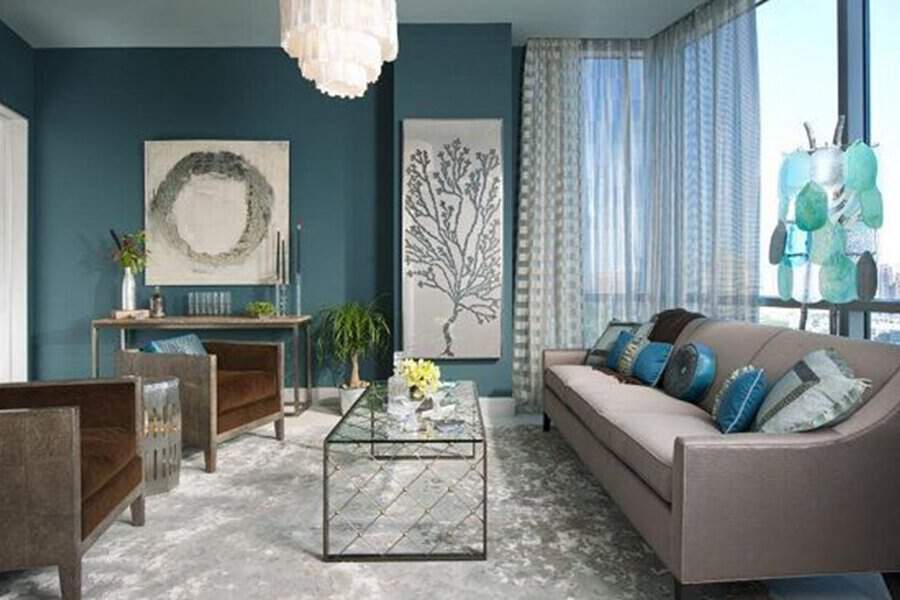 Navy blue living room with aqua accents, elegant decor, and floor-to-ceiling windows.