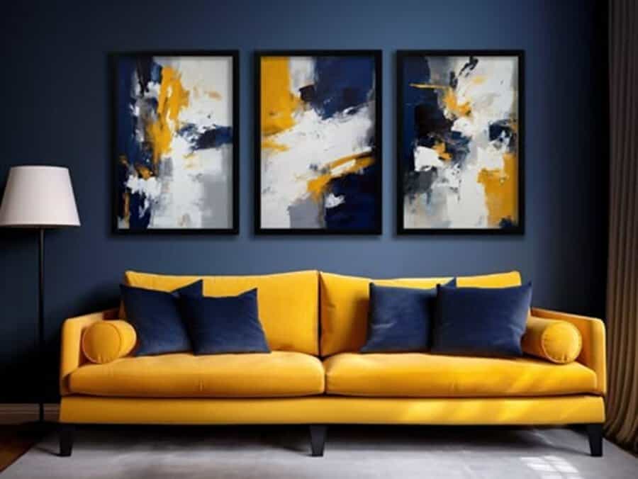 Navy blue living room with a mustard yellow sofa, navy pillows, and abstract triptych wall art.
