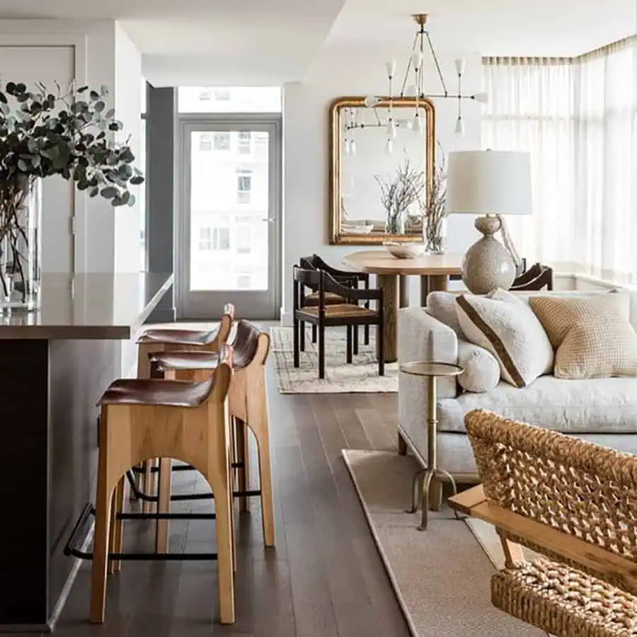 Sophisticated open-concept space with mixed wood tones, woven textures, and elegant neutral decor.