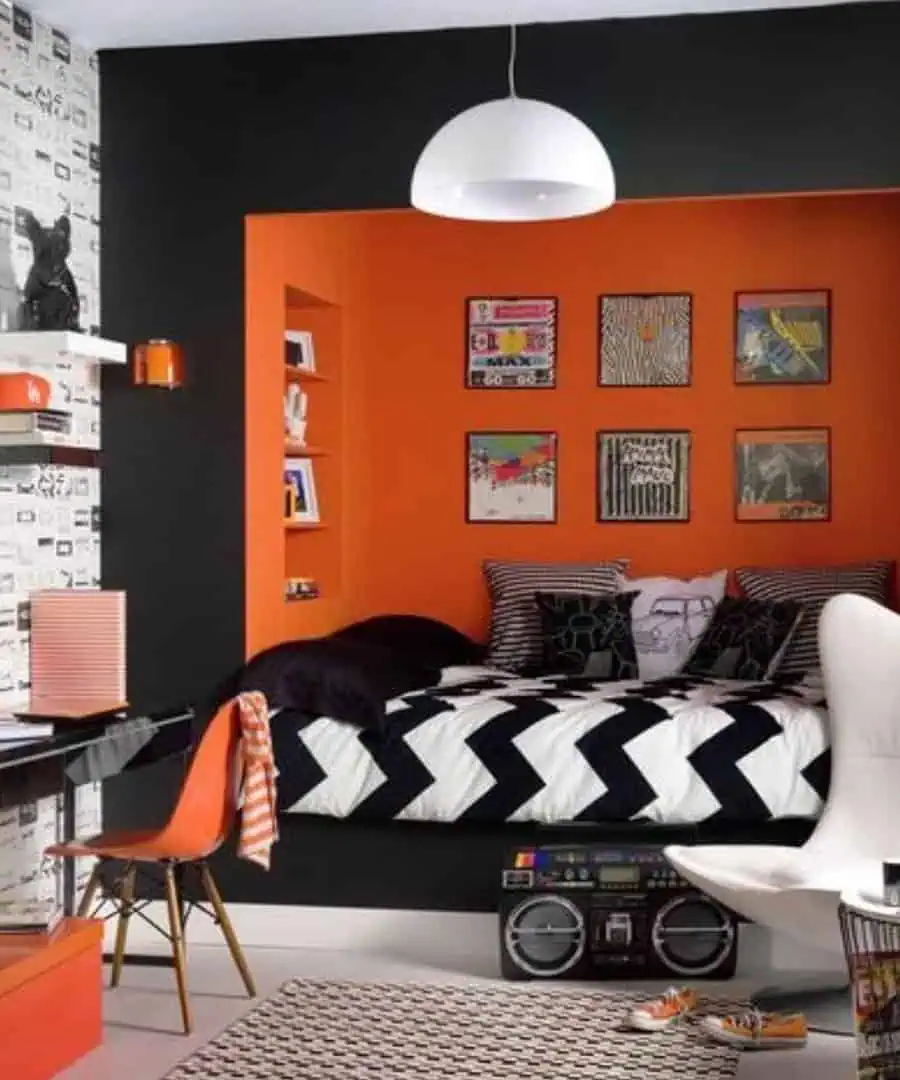 Orange bedroom with dark accents, bold contrasts, layered textures, and modern statement decor.