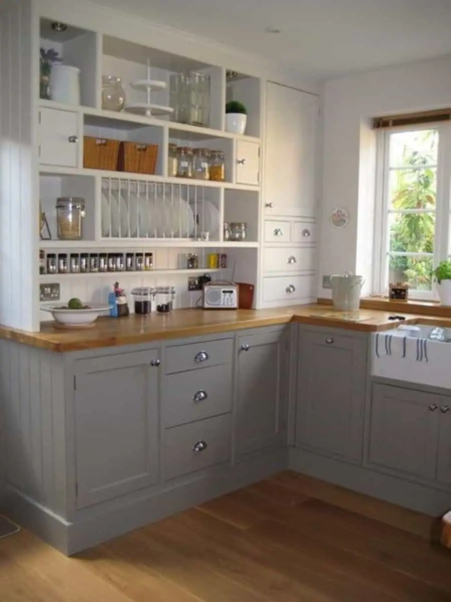 Simple kitchen design with a two-tone color scheme, gray cabinets, wooden countertops, and open shelving.