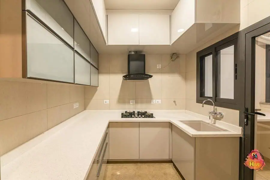 Simple kitchen design with seamless cabinetry, glass panel accents, and a neutral color palette for a sleek look.