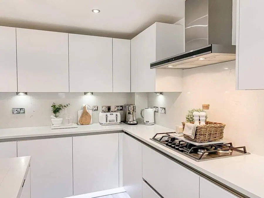 Simple kitchen design with seamless white cabinetry, minimalist handles, and a sleek modern finish.