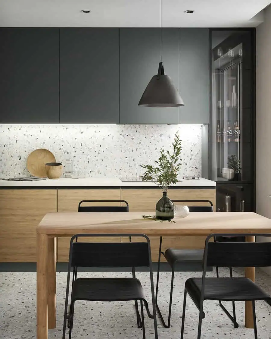 Simple kitchen design with natural wood cabinets, modern black finishes, and a terrazzo backsplash.