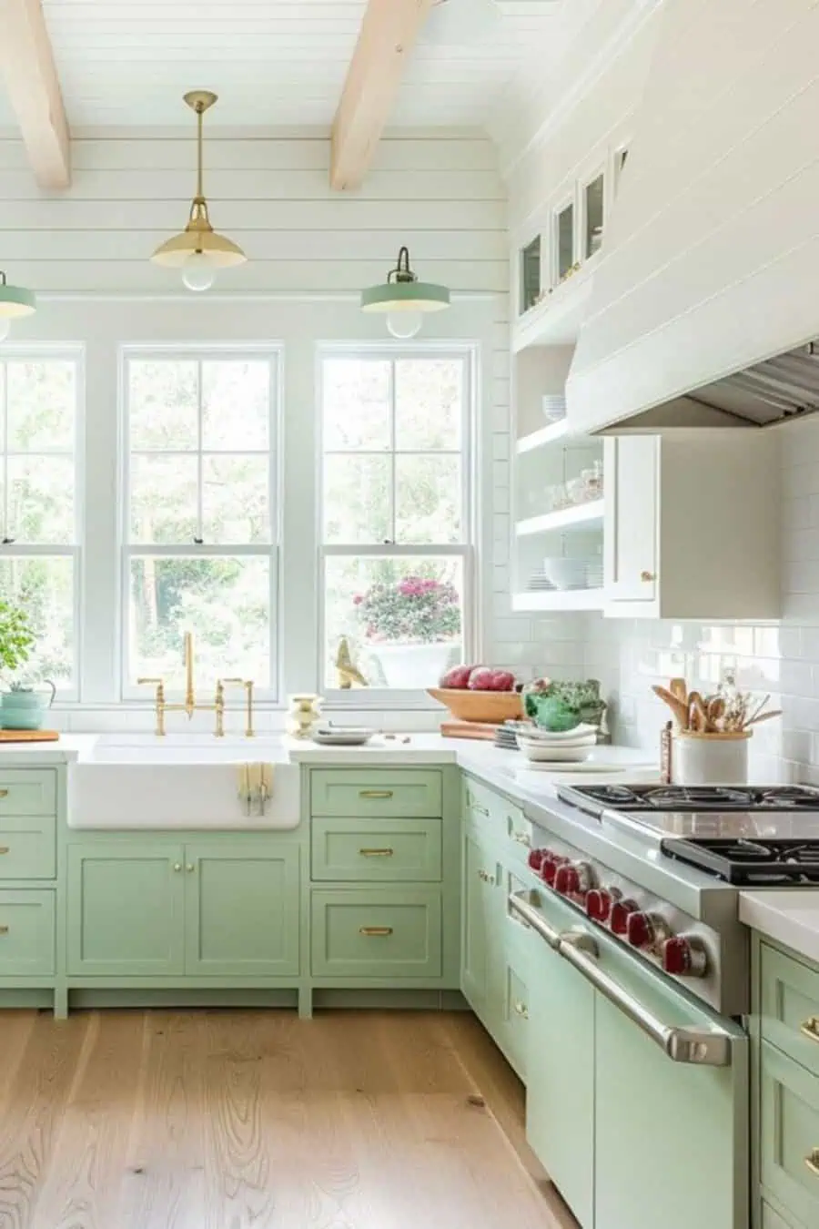 Simple kitchen design with pastel green cabinets, large windows, glass shelving, and airy natural light.