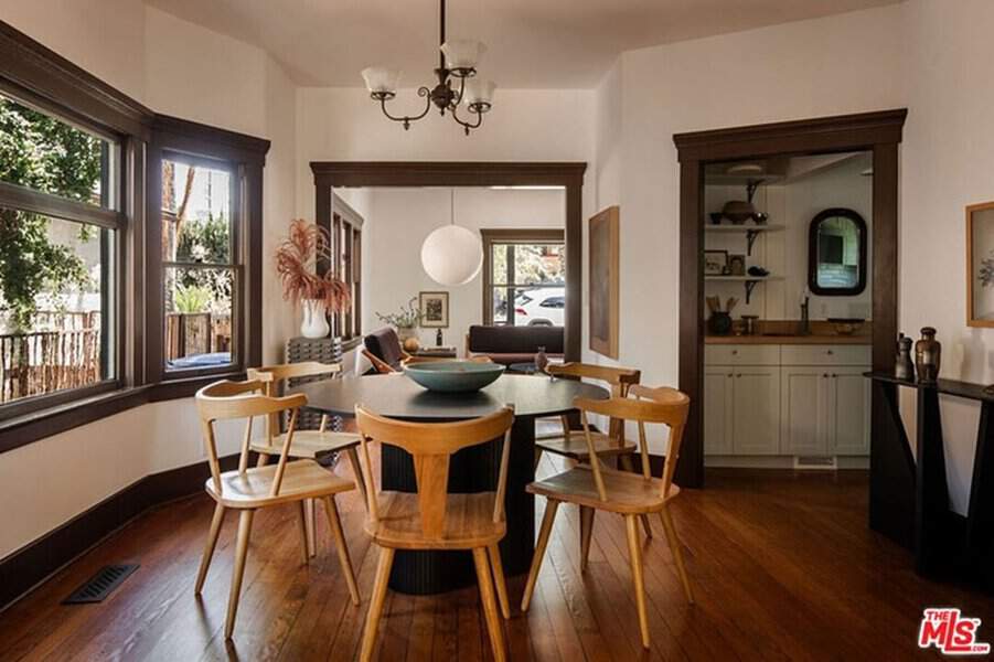 Small Dutch Colonial house interior with wooden floors, dark trim, and a cozy dining area.