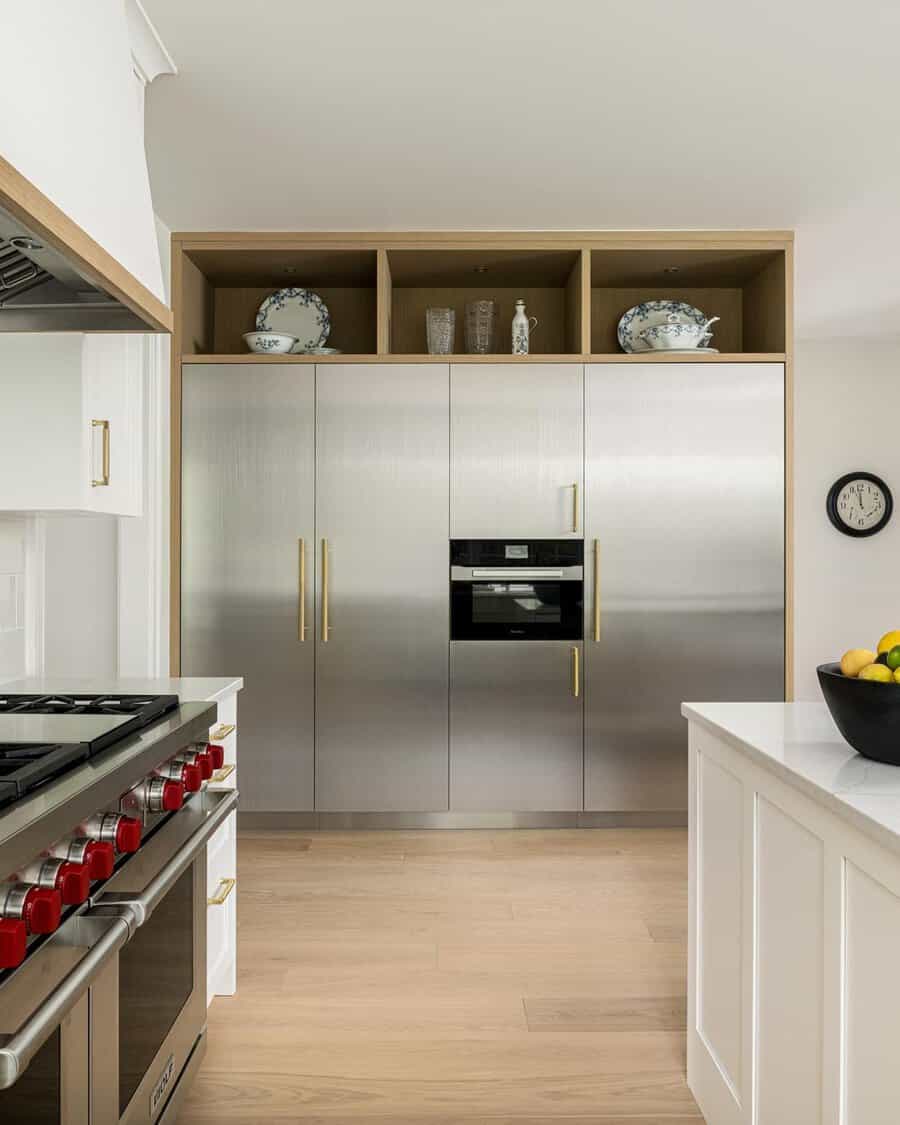 Modern open kitchen with stainless steel cabinets, built-in oven, and smart storage solutions.