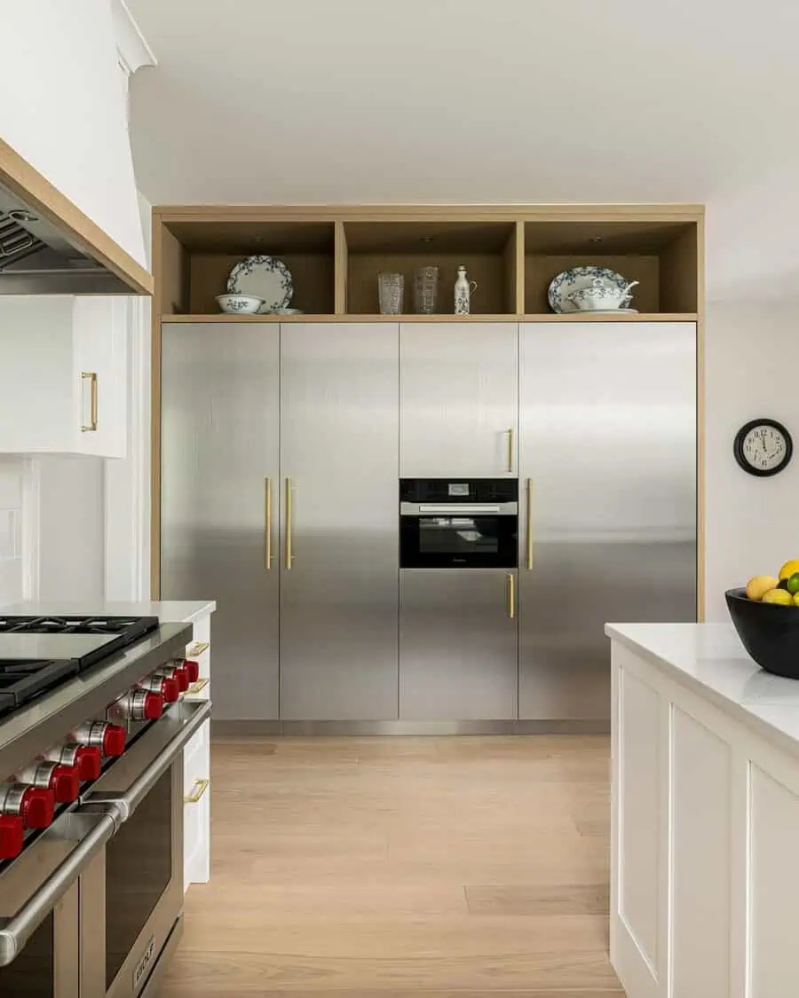 Modern open kitchen with stainless steel cabinets, built-in oven, and smart storage solutions.