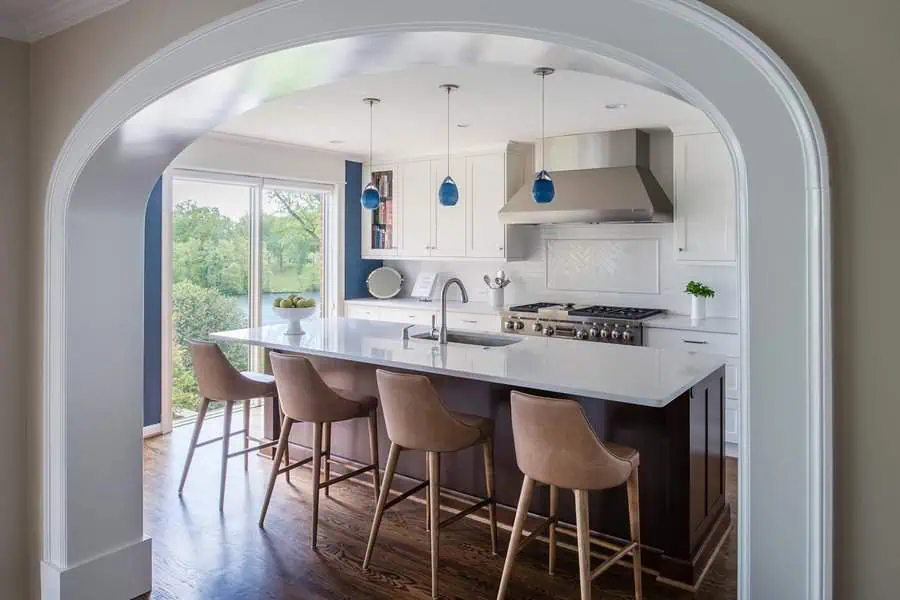 Small open kitchen with a large island, smart storage, and elegant pendant lighting.