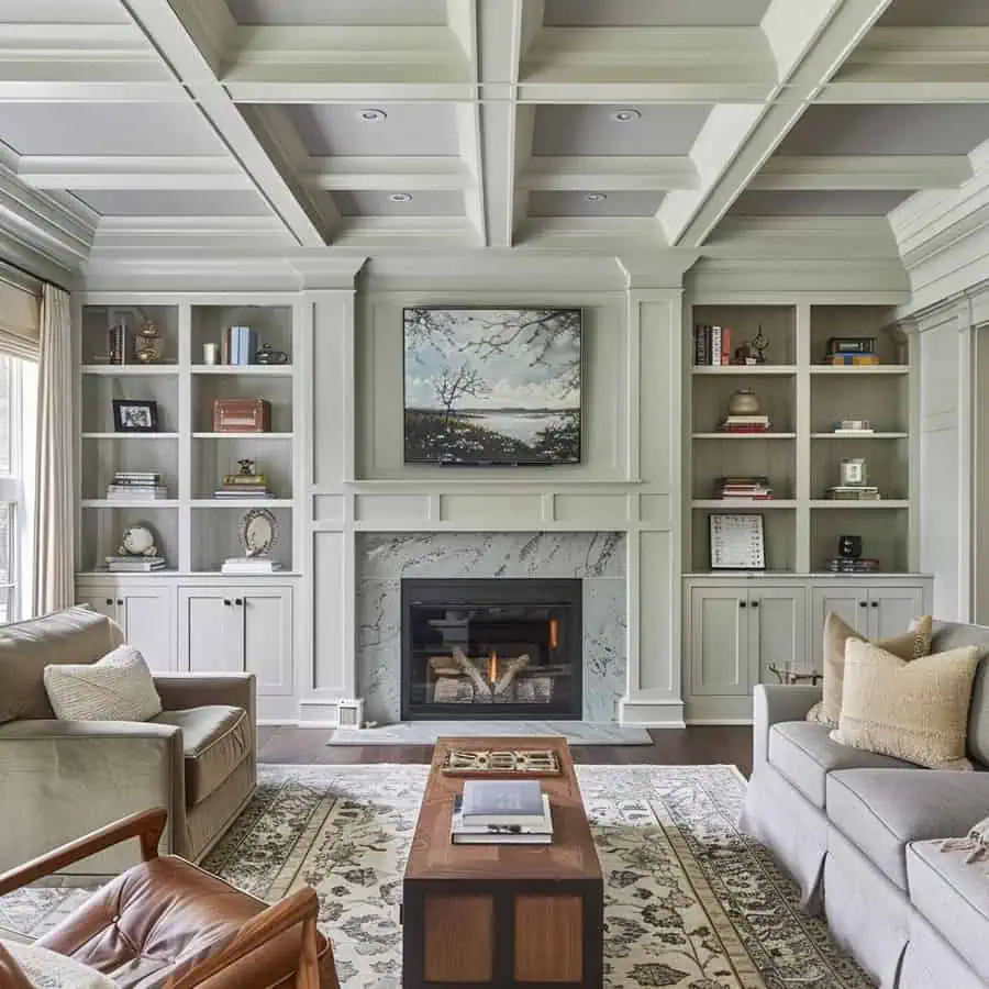 Elegant living room with a coffered ceiling, built-in shelves, a fireplace, and cozy seating.