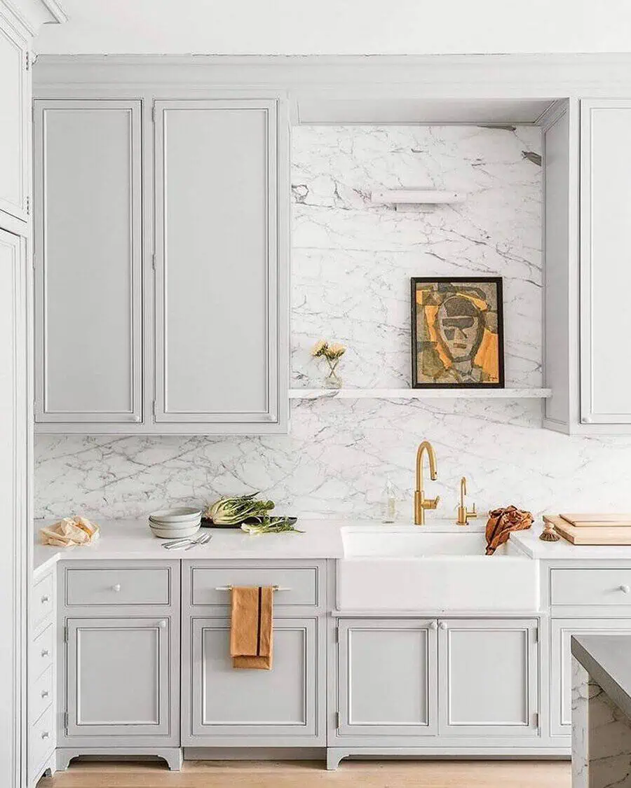 White marble backsplash pairs seamlessly with white cabinets for a sleek, timeless, and elegant kitchen.