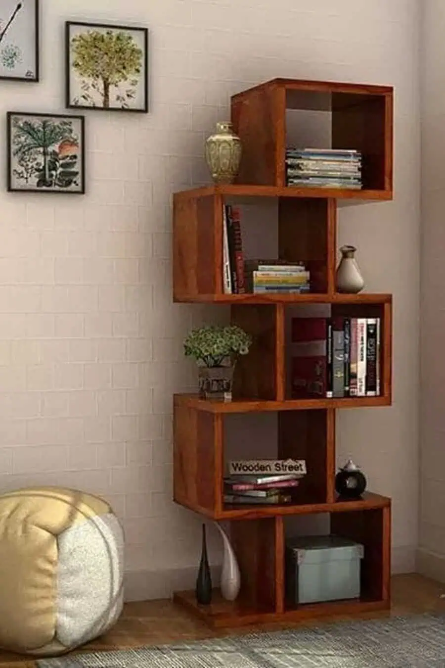 Modern wooden bookshelf with a geometric design, books, decor accents, and a cozy corner setup.