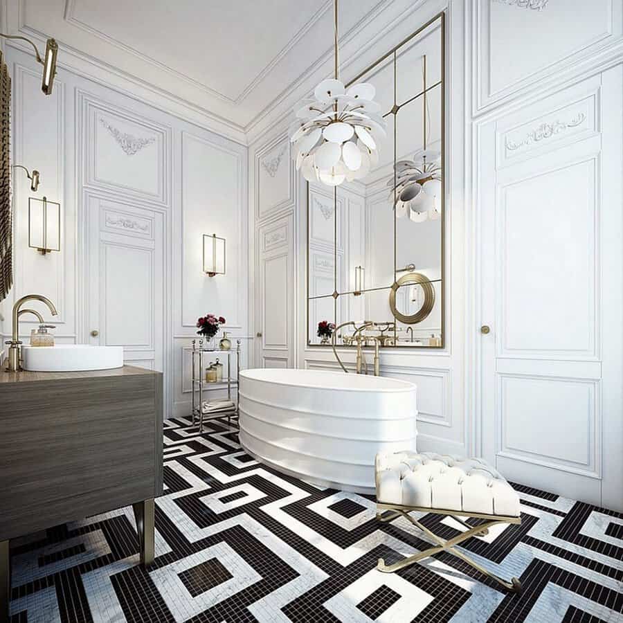 Layered white pendant in a neo-classical bath with ornate paneling, geometric floor tile, and gold fixtures.