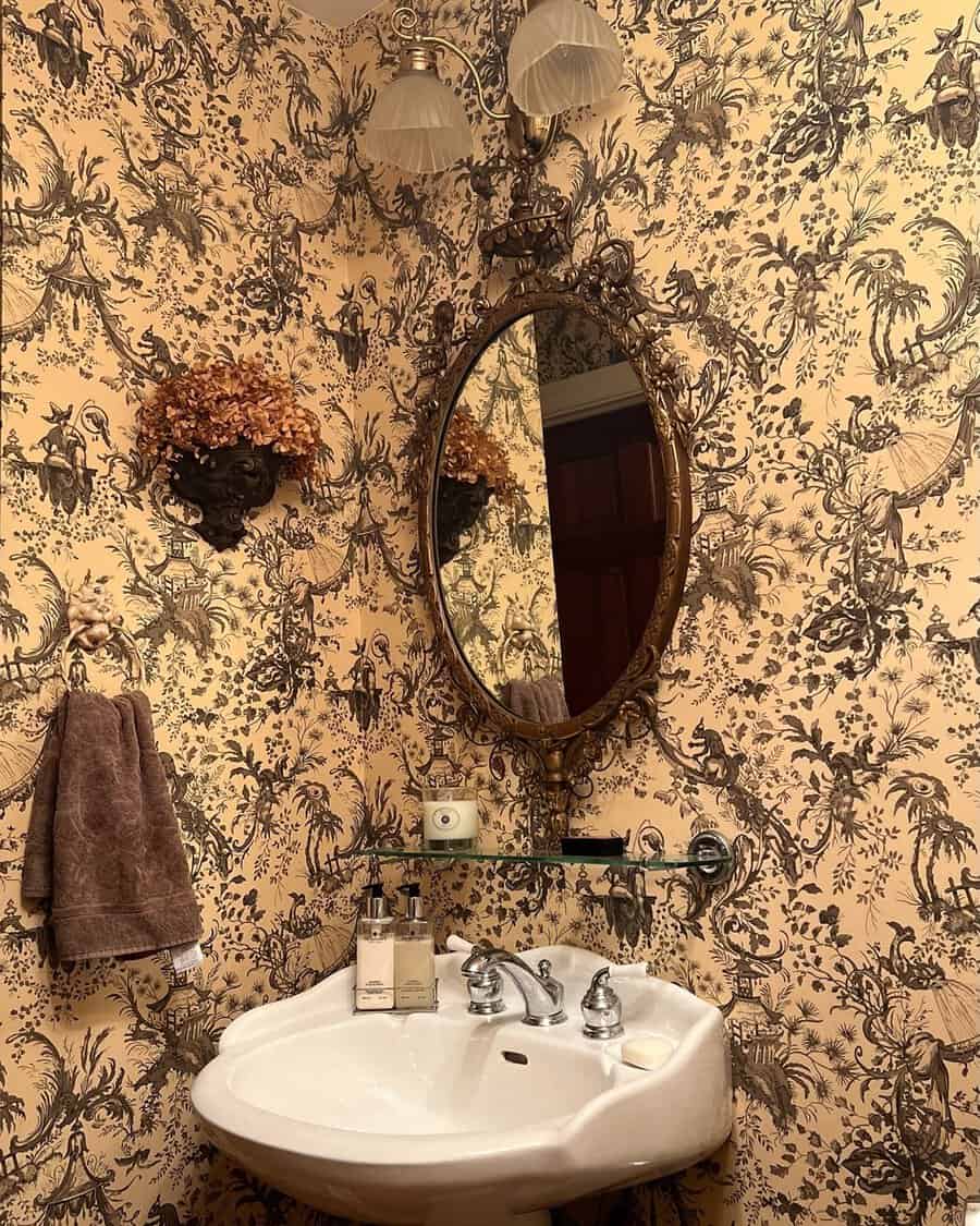 Gold chandelier with fabric shades in a toile wallpaper bath nook featuring draped curtains and a ceiling medallion.