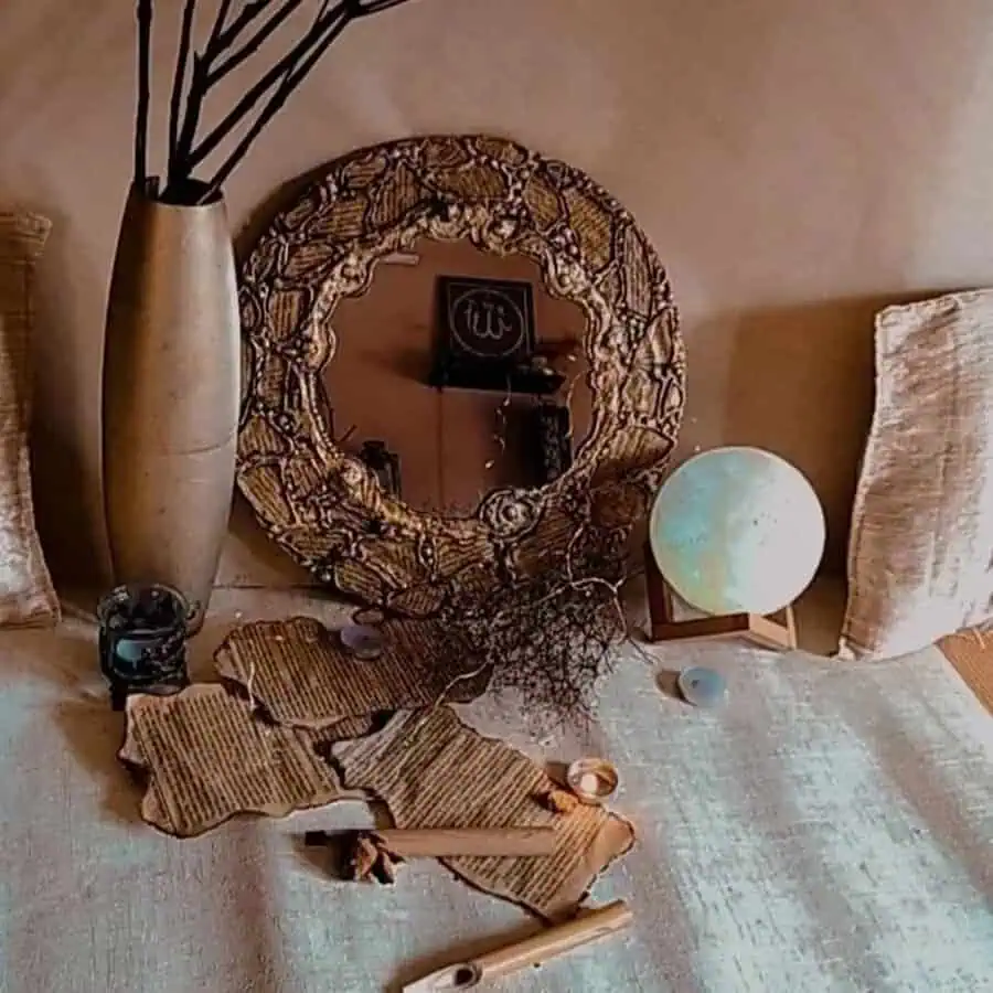 Ornate boho mirror with textured details, surrounded by earthy accents and candlelight on a soft neutral backdrop.