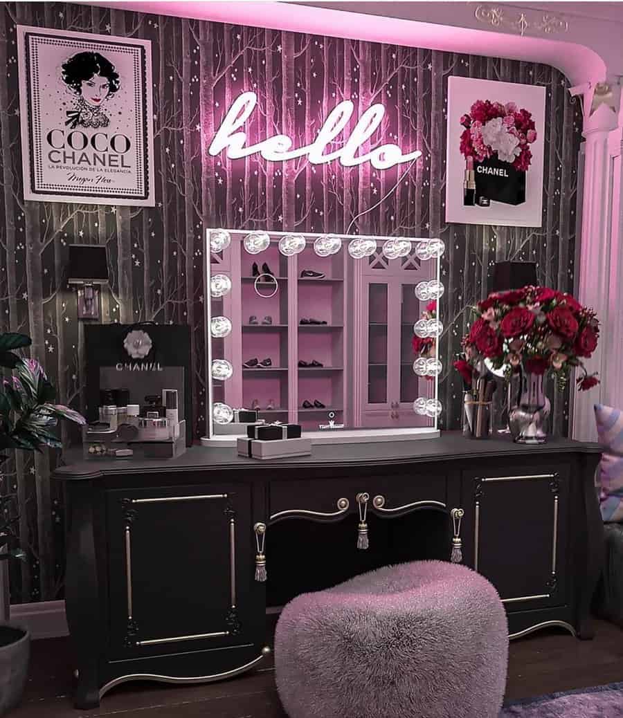 Pink neon "hello" sign above a chic vanity, adding a bold and modern touch to a stylish, glamorous bedroom setup.