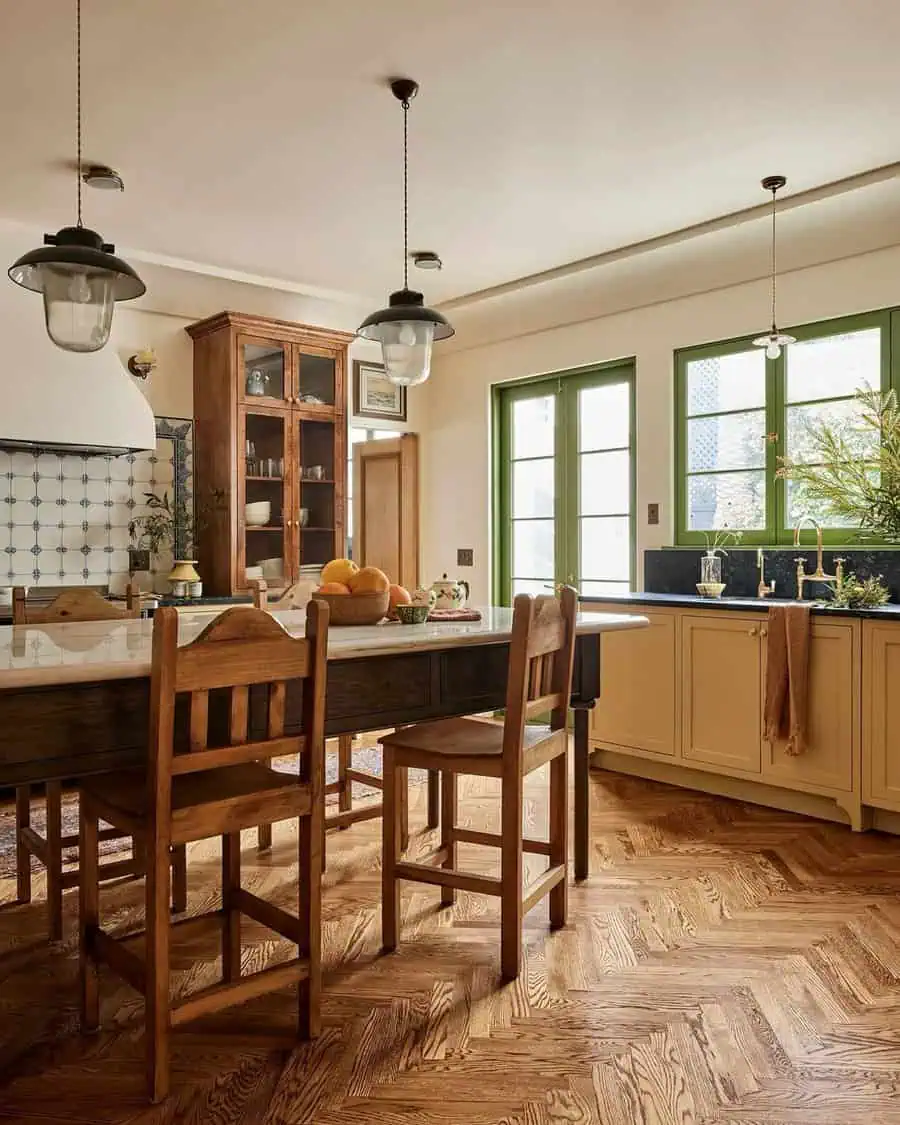 Colonial Spanish-style kitchen with green windows, wood cabinetry, a tile backsplash, herringbone flooring, and rustic pendant lighting.