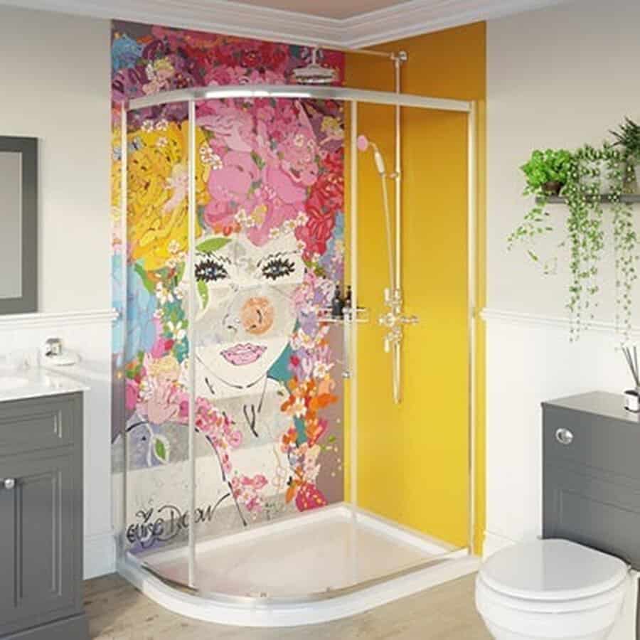 Shower area with a colorful floral mural, bold yellow wall, and gray vanity for a vibrant bathroom design.