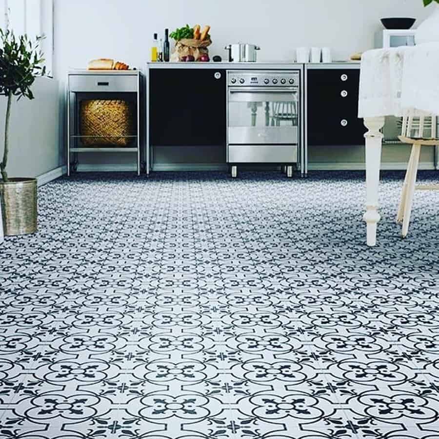 Black-and-white patterned kitchen tiles contrasting with sleek cabinetry for a bold, contemporary look.