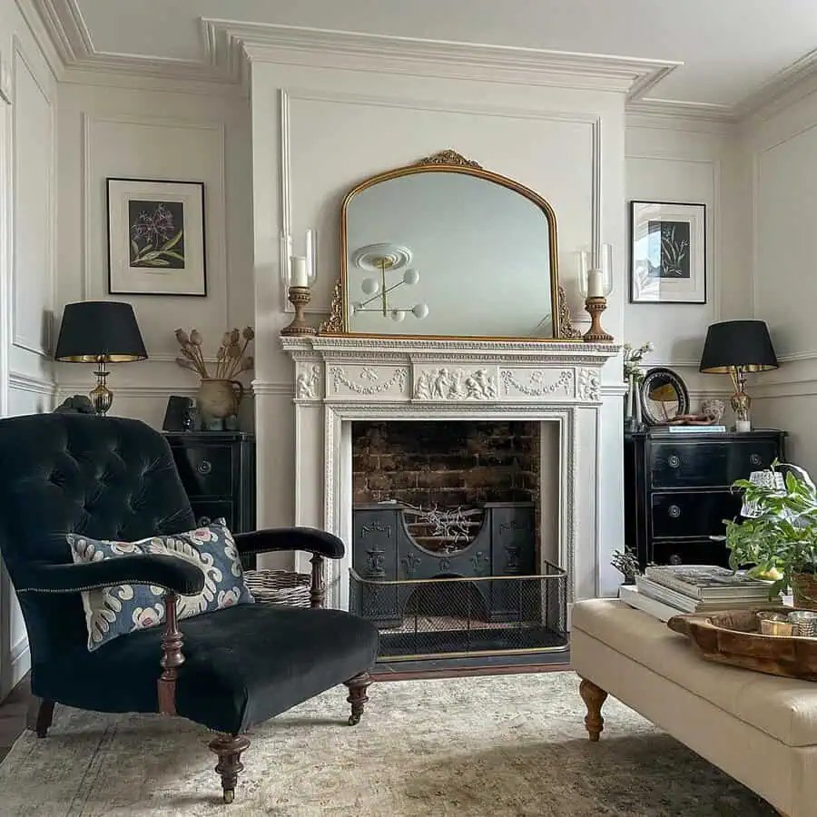 Luxurious Georgian-inspired living room featuring a carved white mantel, velvet armchair, and refined black-and-gold decor.