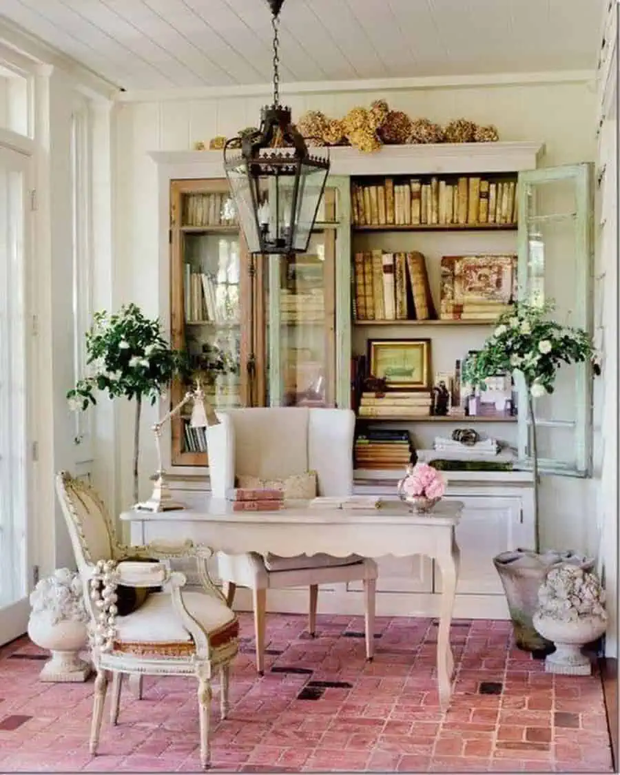 Cozy vintage-inspired office with natural light, soft furniture, and a charming mix of books and plants for a peaceful atmosphere.