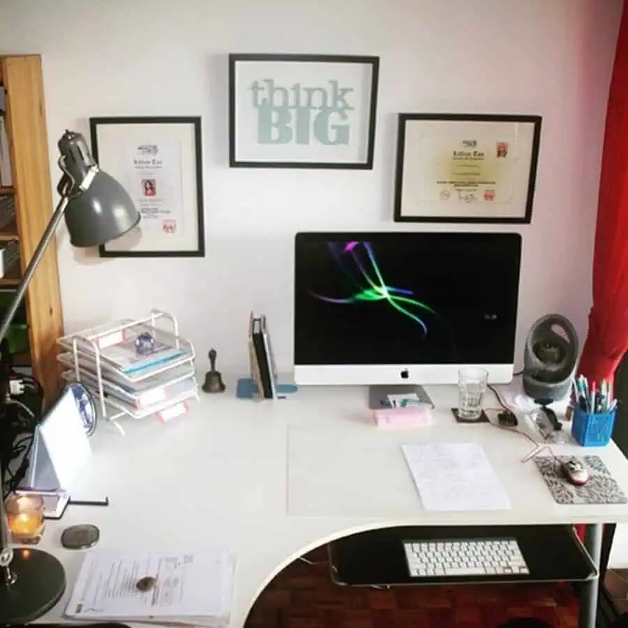 Home office with motivational wall art and framed certificates for daily inspiration.