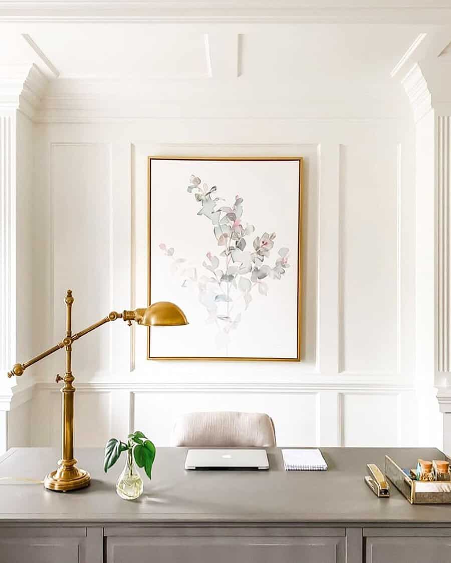 Crisp white office with gold accents, minimal decor, and balanced feng shui for a serene workspace.