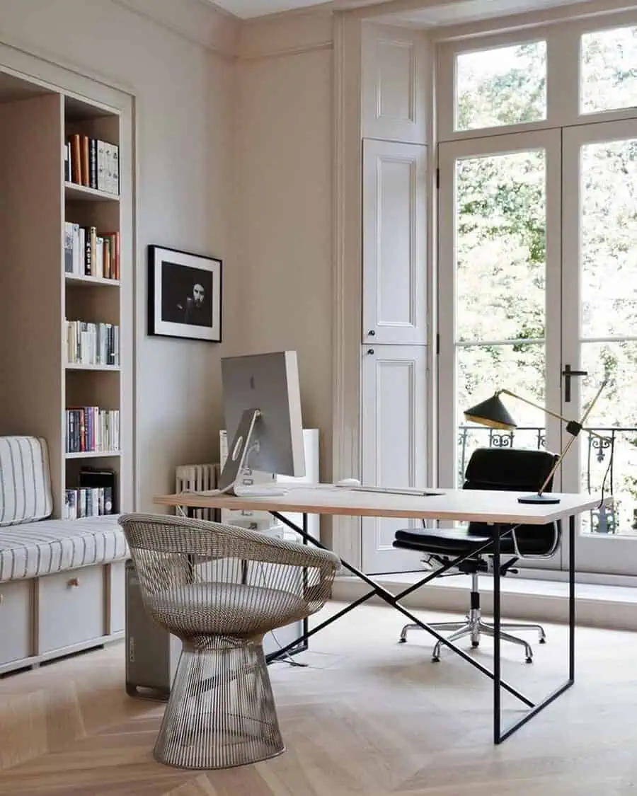 Bright home office with natural light streaming in through large windows, creating a spacious and productive environment.