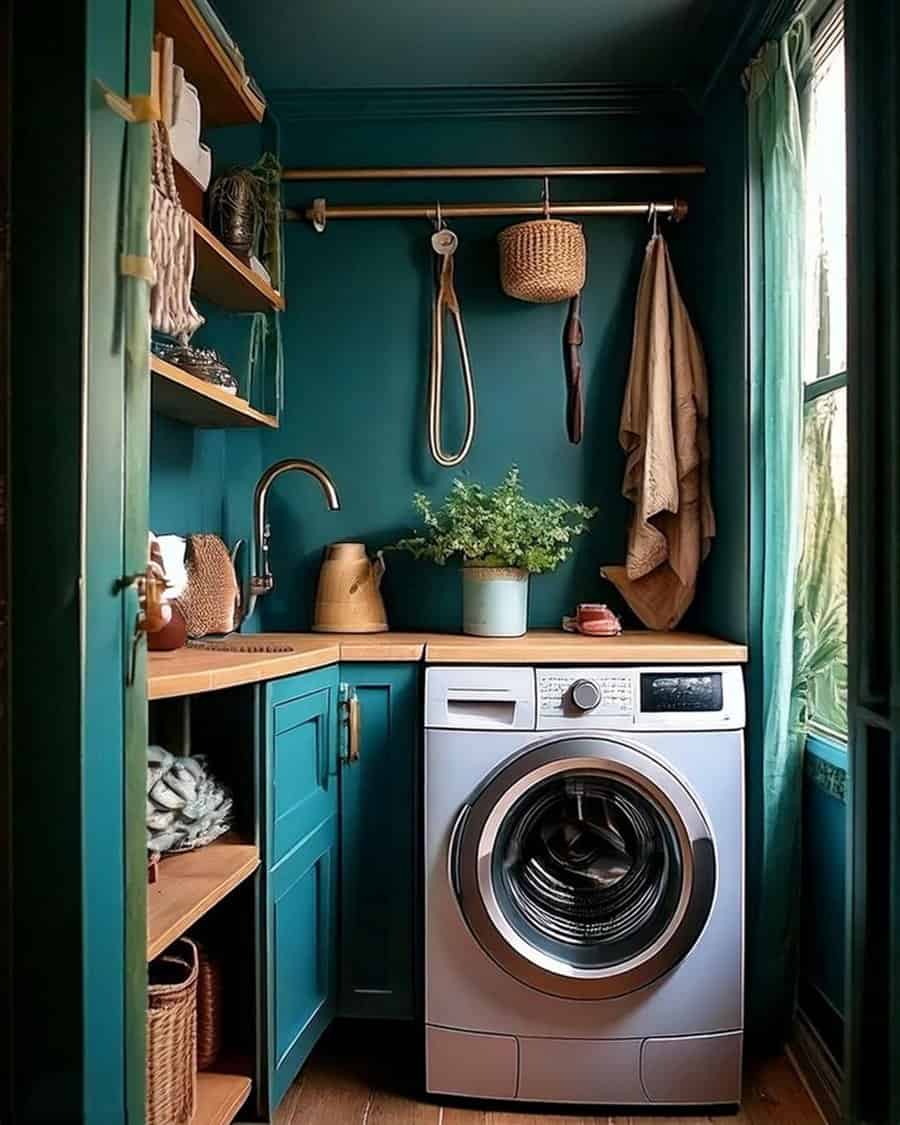 Teal laundry nook with wood counter, brass rod, open shelves, and front-loading washer.