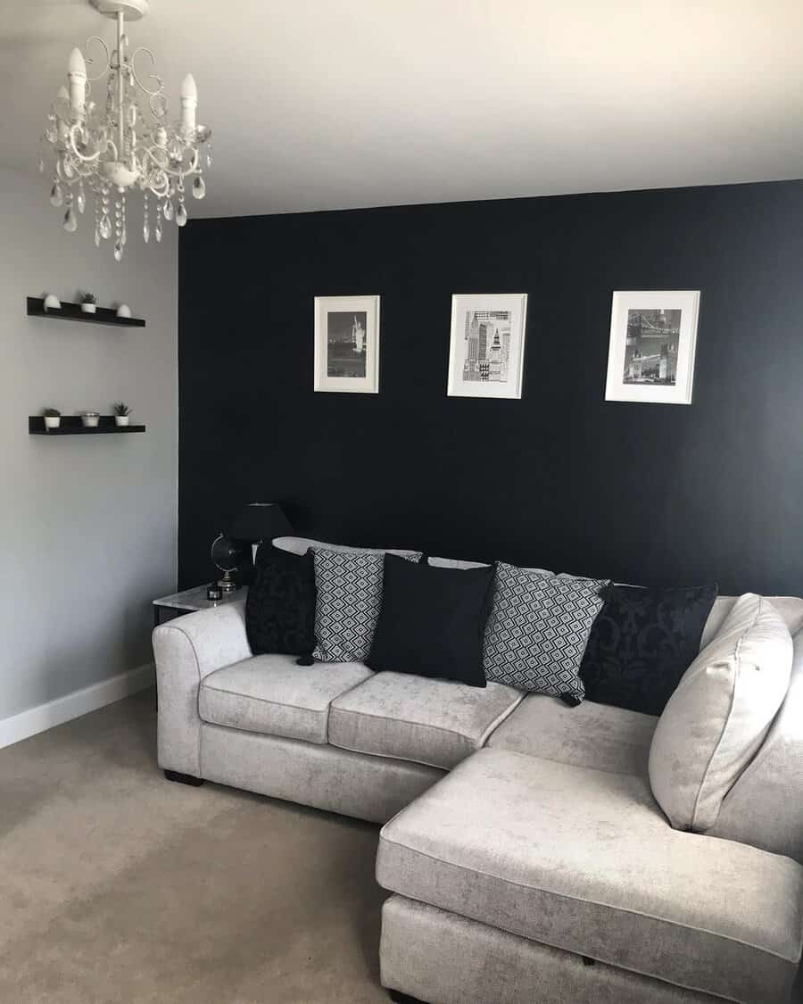 Living room with a bold black accent wall, neutral sofa, and monochrome decor creating a striking modern look.