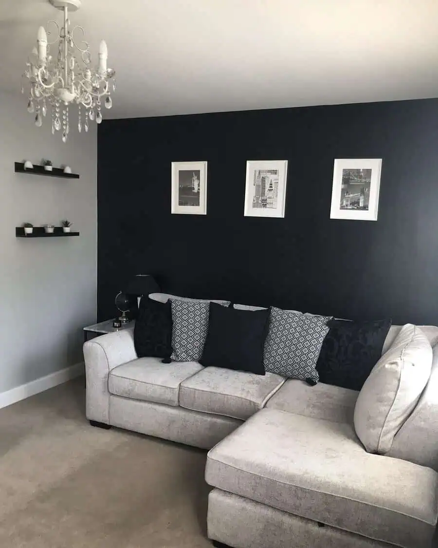 Living room with a bold black accent wall, neutral sofa, and monochrome decor creating a striking modern look.