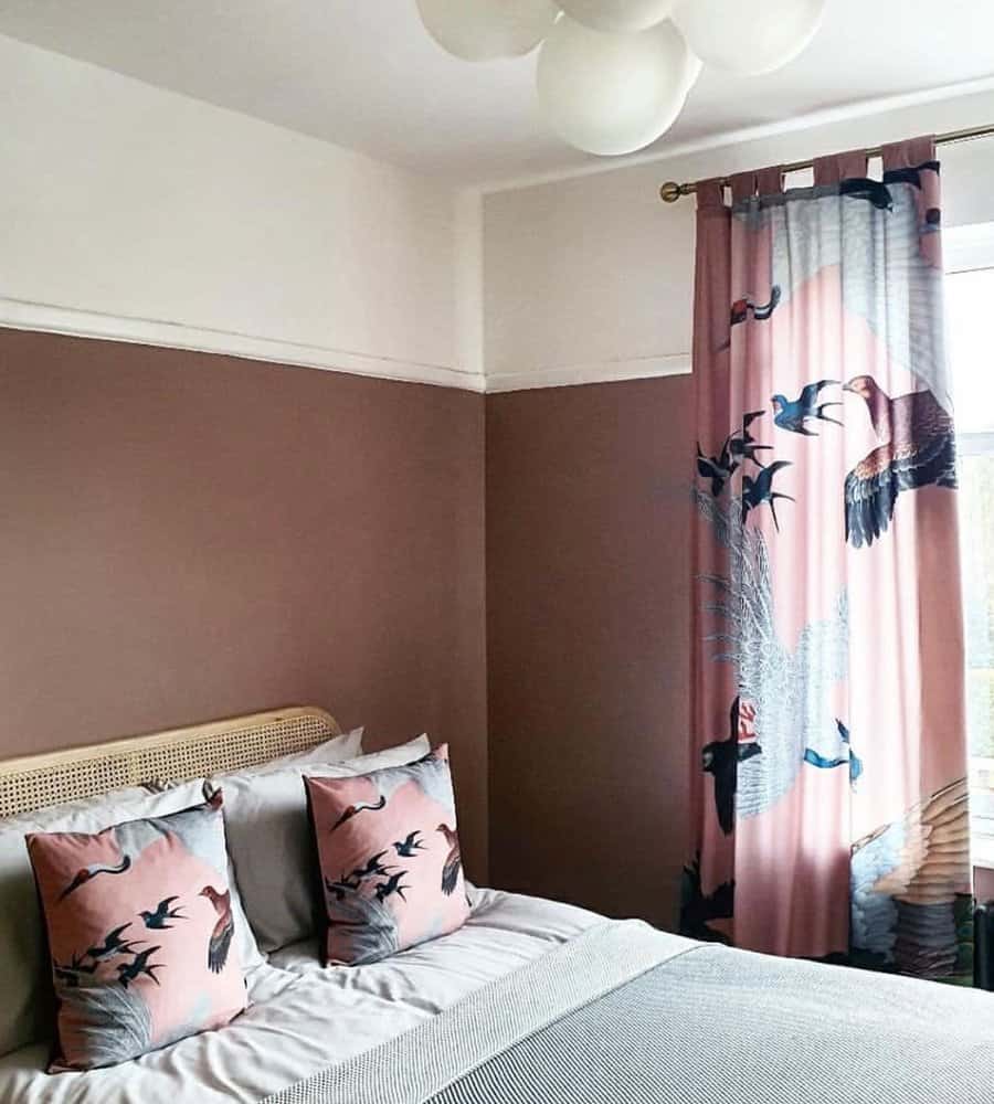Bold patterned curtains with crane motifs add movement and elegance to a stylish bedroom with warm, earthy tones.