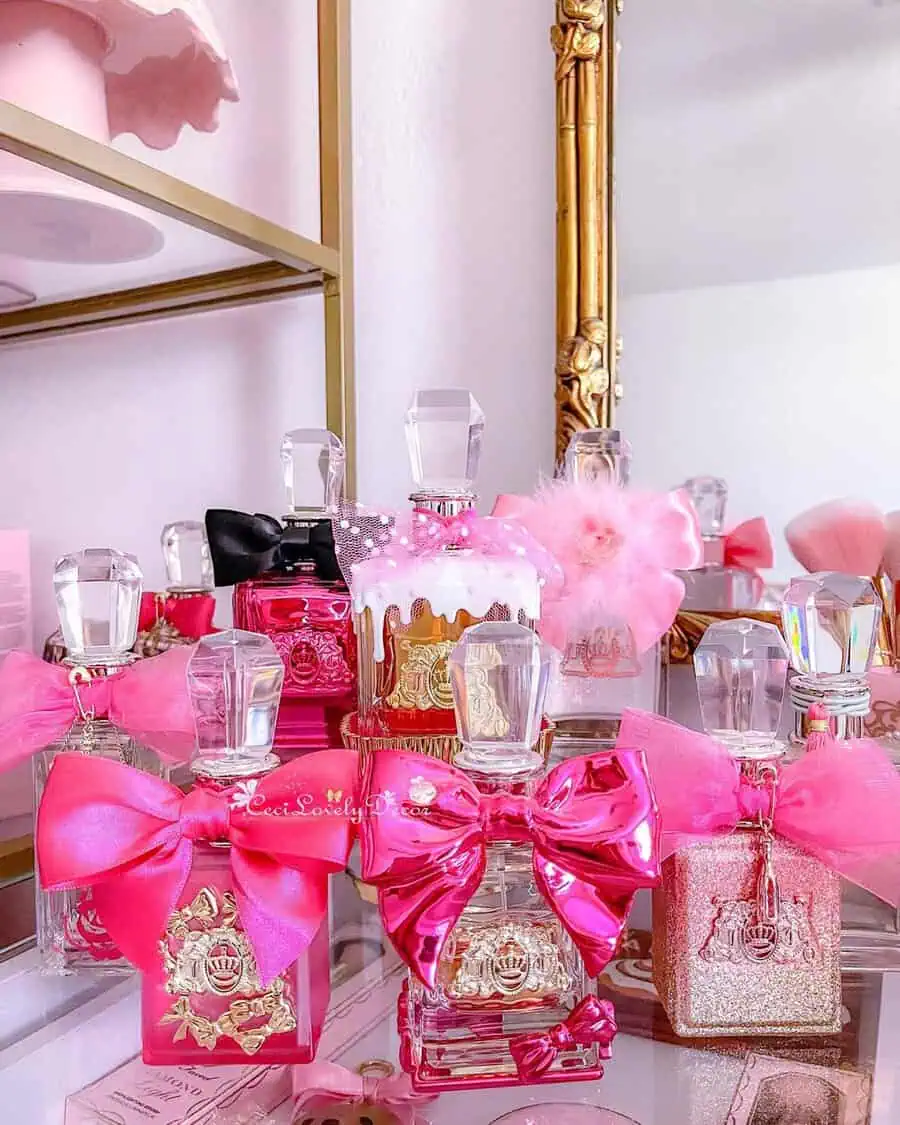 Pink perfume bottles with gold details and bows add a glamorous and feminine touch to a vanity display.