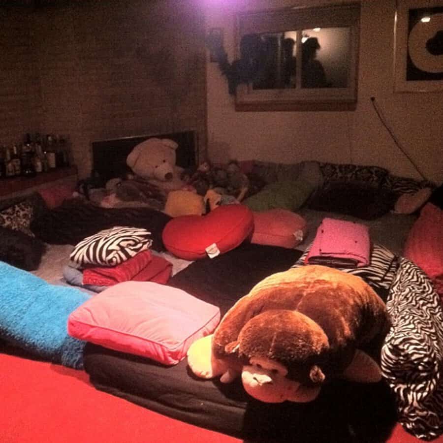 Pillow pit filled with cushions, blankets, and stuffed animals for a fun, cozy hangout spot.
