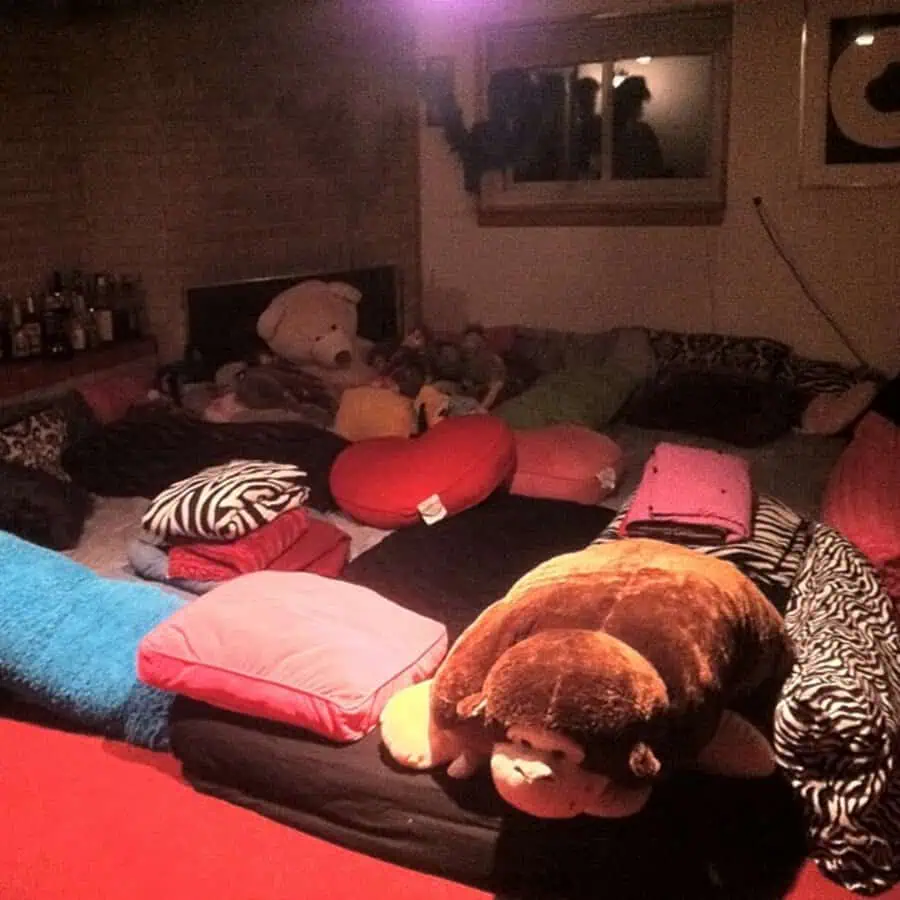 Pillow pit filled with cushions, blankets, and stuffed animals for a fun, cozy hangout spot.