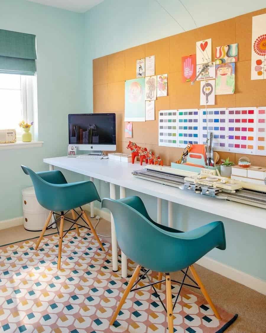 Light, airy home office with teal chairs, cork board, white desk, and a colorful geometric rug for a fun, organized spare room.