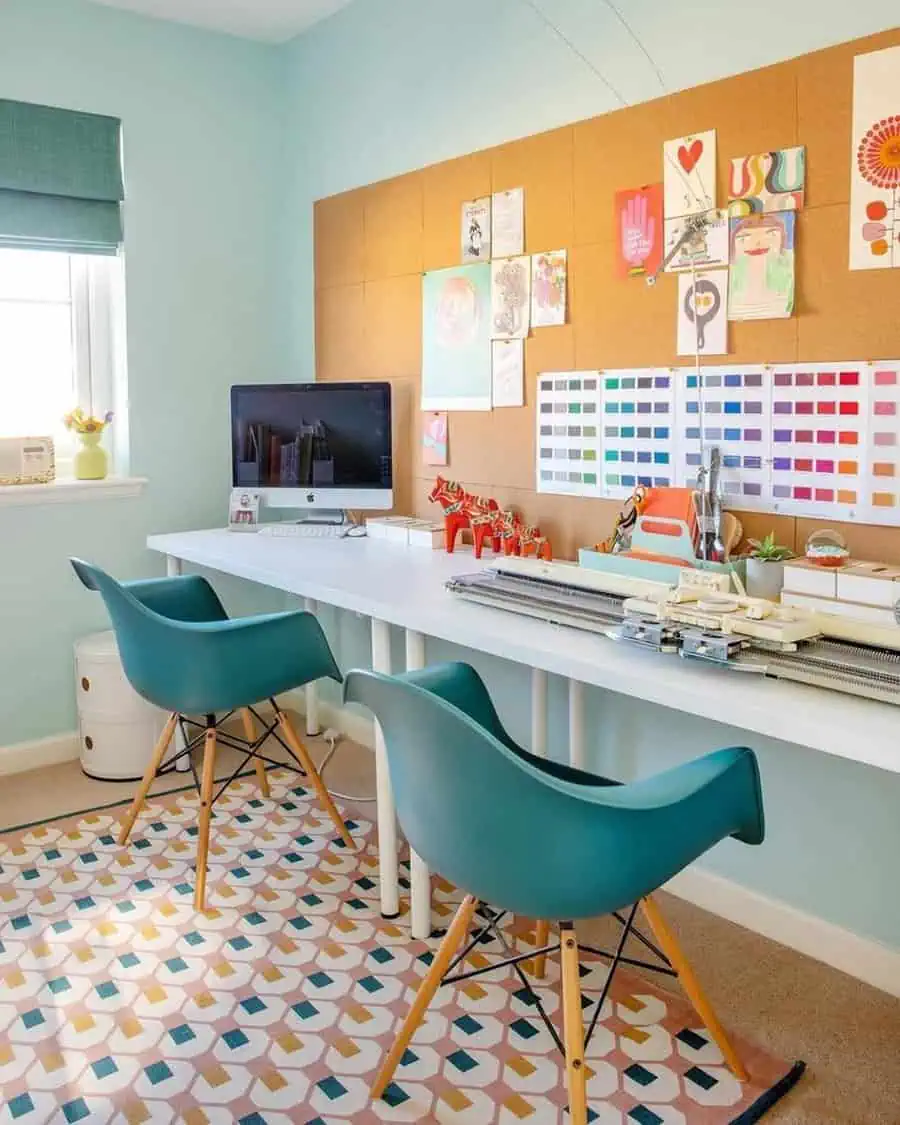 Light, airy home office with teal chairs, cork board, white desk, and a colorful geometric rug for a fun, organized spare room.