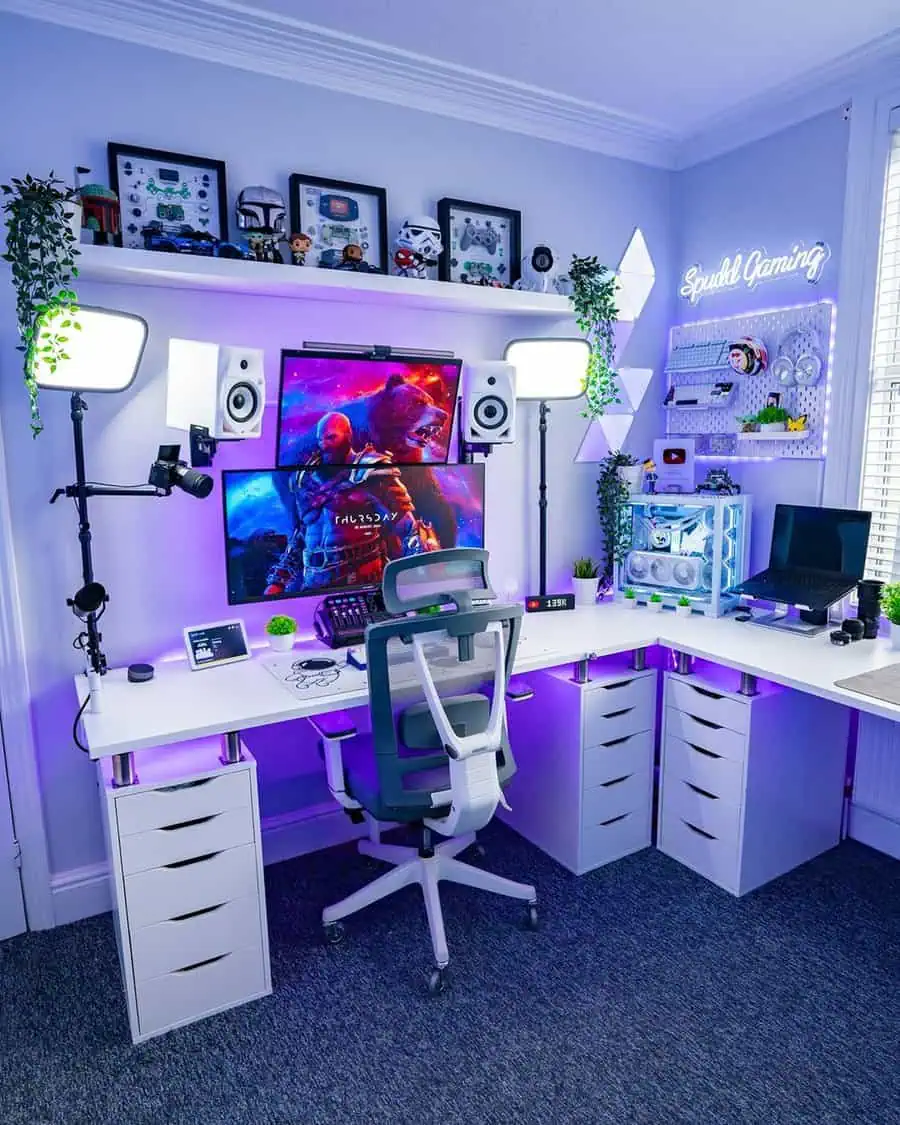 Gaming setup with wraparound desk, purple LED lights, collectibles, and multiple monitors for an immersive home gaming station.