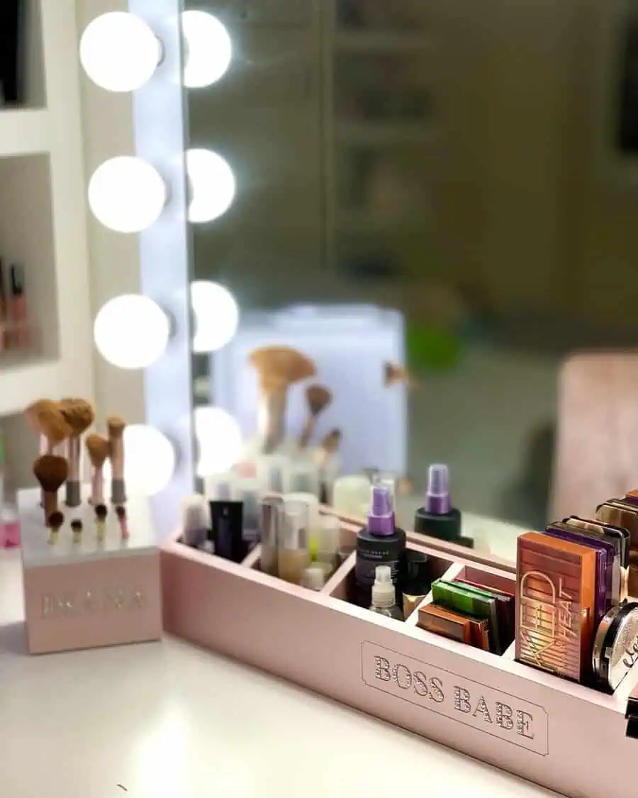 Pink makeup stand with labeled compartments keeps beauty products organized while adding a stylish, feminine touch to a vanity.