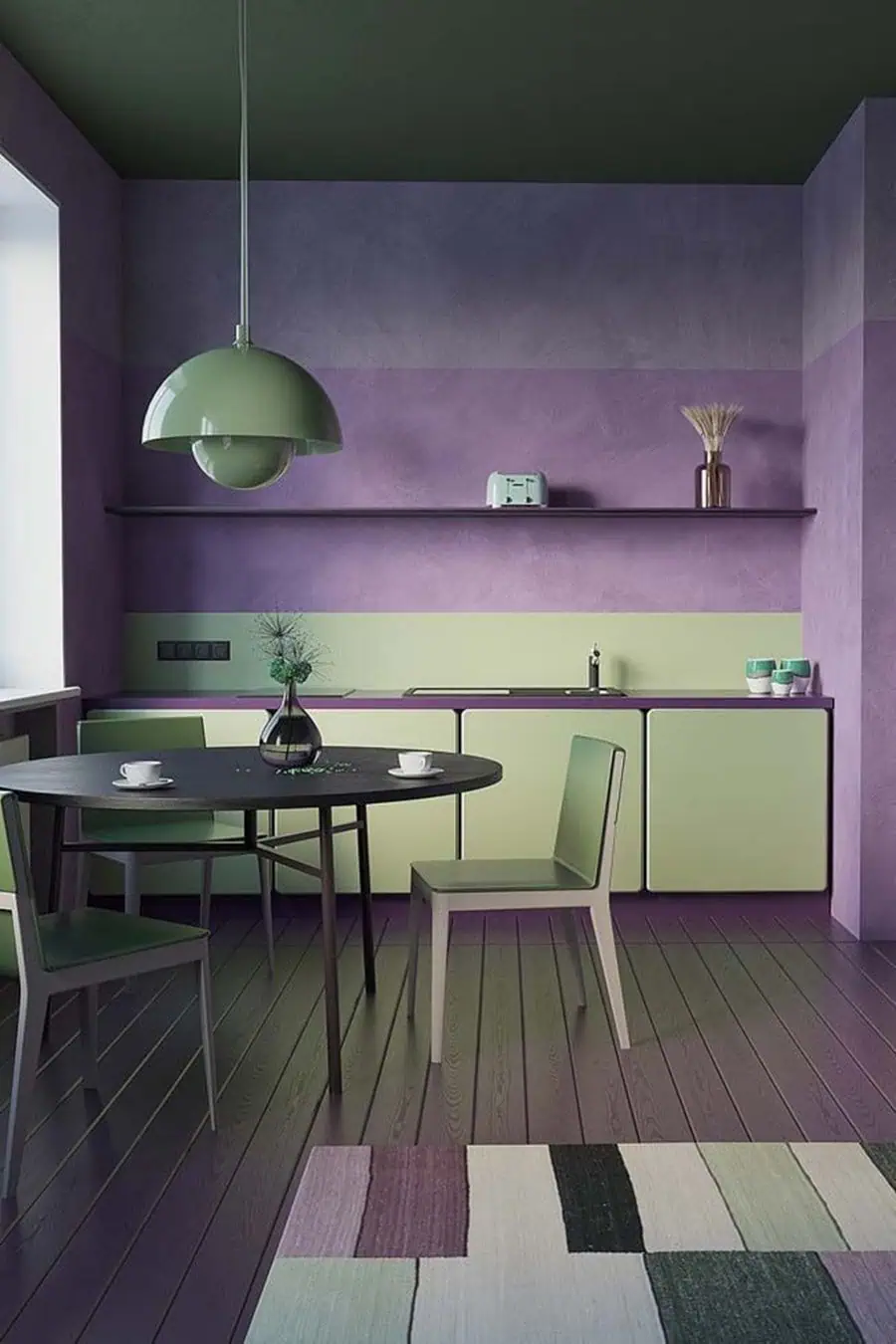 Kitchen with purple painted wood floor, green cabinets, purple walls, and a round black dining table with matching chairs.