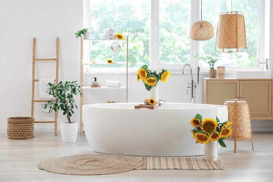 Bathroom with sunflowers, woven textures, a white freestanding tub, and natural wood details for a bright and refreshing look.